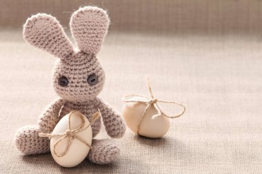 Easter knitted bunny toy with easter eggs.