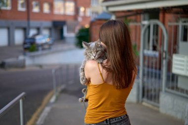 Kız kediyle yürüyor..