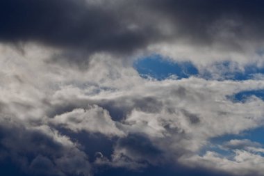 White cirrus clouds seem to spread across the bright blue background.