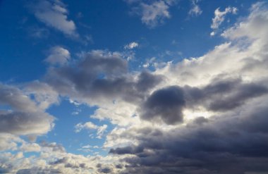 Lines and shapes of clouds form a unique pattern against the blue sky.