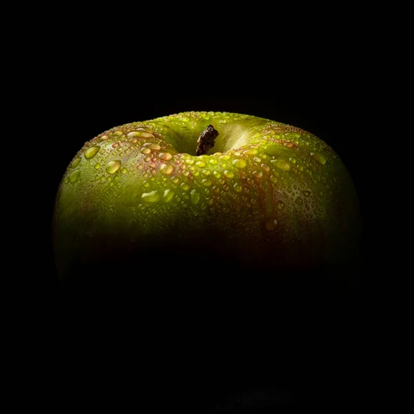 apple on black phoe with drops of water