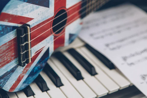 Ukulele and piano keys — Stock Photo, Image