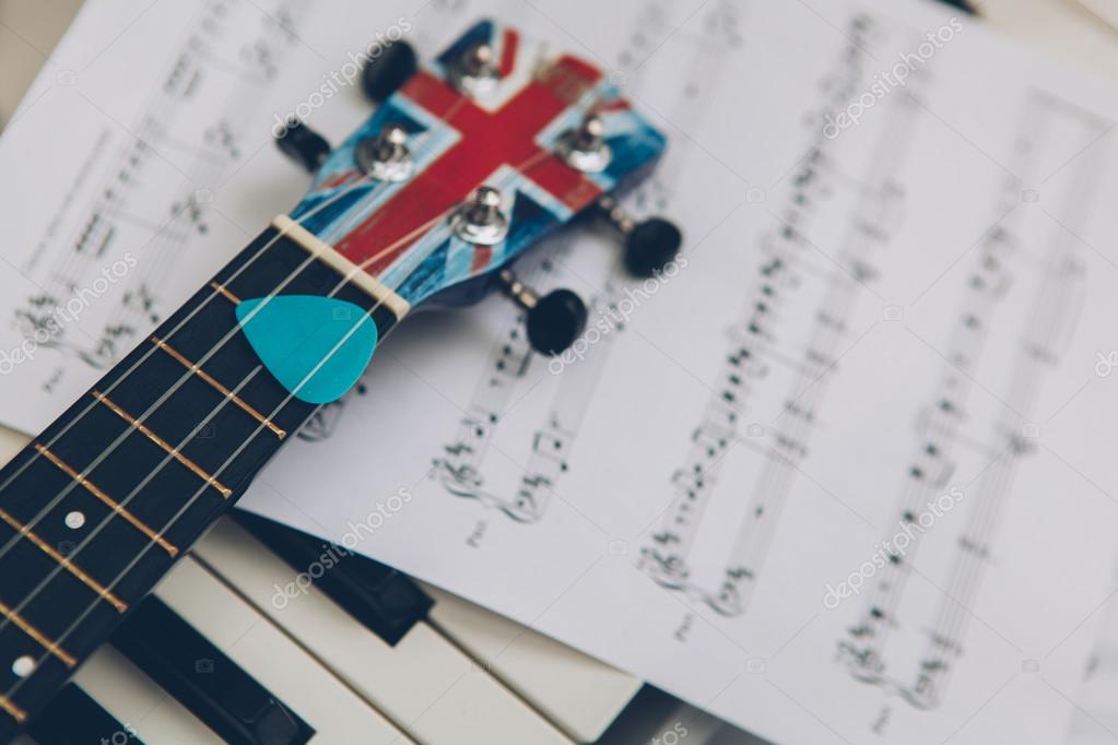 Ukulele and piano keys — Stock Photo © mimiau 70421885