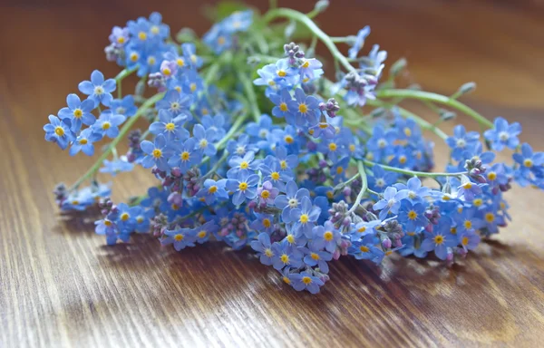 Forget me nots lying on the table — Stock Photo, Image