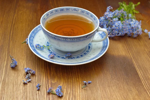 Old china tea cup with bouquet of forget me nots — Stock Photo, Image