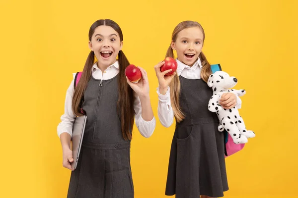 Healthy teeth, yummy eat. Happy kids hold apples. School snack. Dental health education. Prevention of caries. Pediatric dentistry. Teeth are always in style.