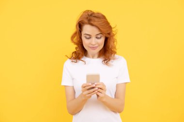 mobile chat app. girl chat online. sms and instant messaging. typing and texting. blogger use smartphone. agile business blogging. modern communication technology. smiling woman working online.