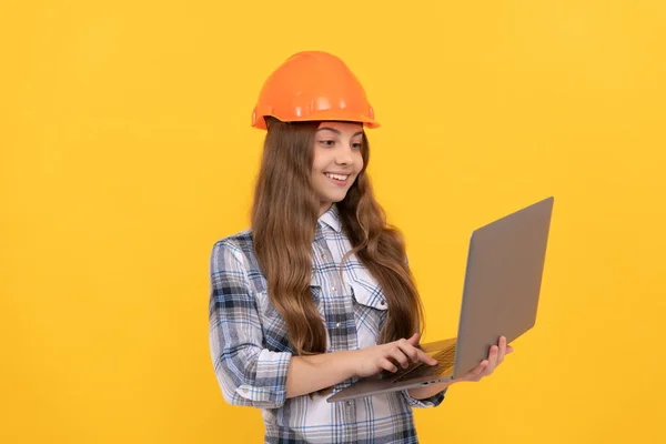 ready to work. childhood online education. happy labour day. future career. teen girl use laptop. builder kid hold computer. building and construction. webinar. happy child worker wear hardhat.