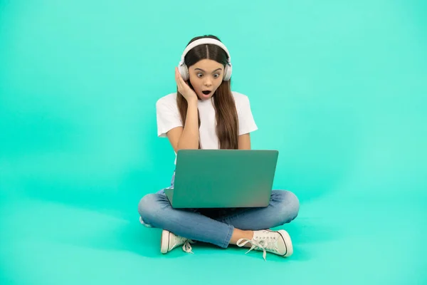 surprised kid chat on computer. buy online. back to school. teen influencer blogging. girl in headphones. music. webinar in wireless headset. modern education. communication technology. video call.