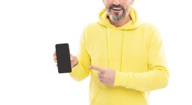 Kesilmiş kapüşonlu adam akıllı telefon ekranı sunuyor. Kopyalama alanını işaret ediyor. Beyazda izole edilmiş, reklam..