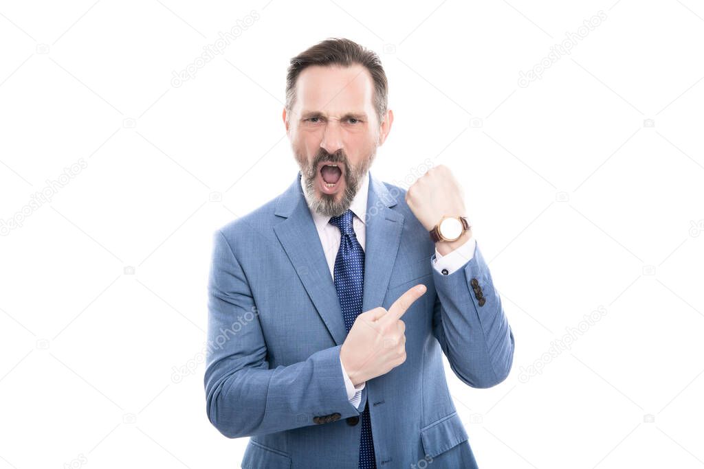 angry mature director with grizzled hair in suit pointing finger on time on watch isolated on white, late.