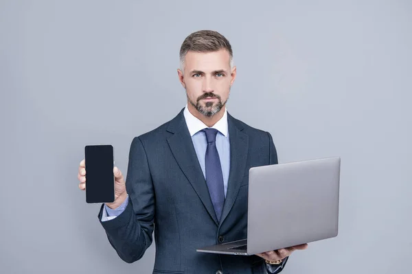 Confident Businessman Man Businesslike Suit Hold Computer Presenting Smartphone Advert — Stock Photo, Image