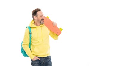 male casual hipster style. copy space. mature happy man carry backpack and penny board clipart