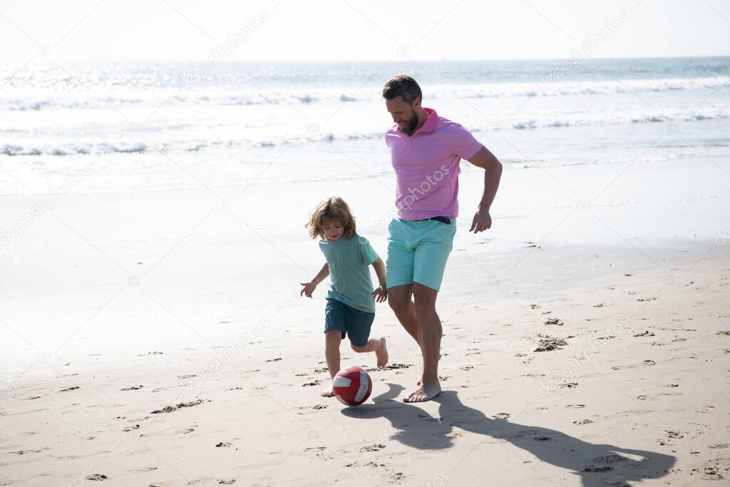 happy father and son playing football having fun on summer sandy beach family vacation, football