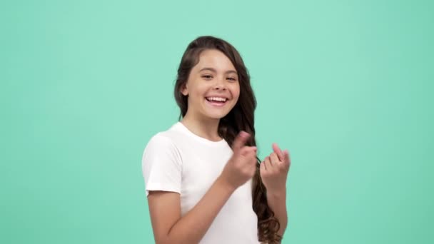 Portrait of happy kid curly hair moving and pointing fingers everywhere and on camera, directing. — Stock Video