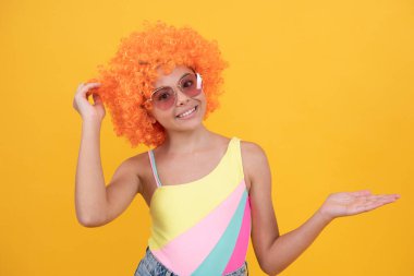 1 Nisan şakası. Mutlu çocukluk. Doğum günü partisi. Kıvırcık palyaço peruğu takan komik çocuk. Eğleniyorum..