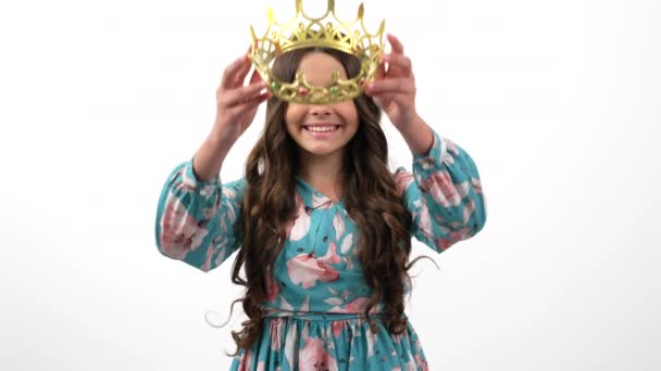 Beautiful cheerful child long curly hair wearing princess crown showing thumb up, prom. — Stock Video