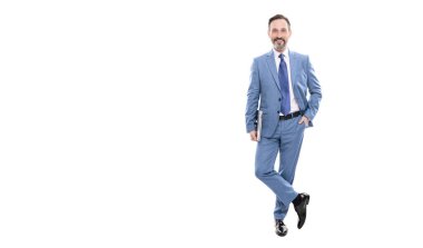 happy grizzled business man in suit full length holding laptop copy space, business professional.