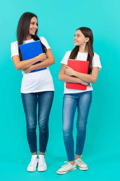 Mom and teen girl study. private teacher and child holding copybooks. family help. — Stock fotografie