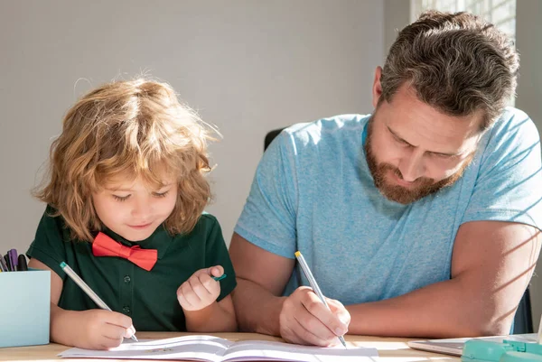 Father and son painting at home. family help. boy do homework with teacher. — Stockfoto