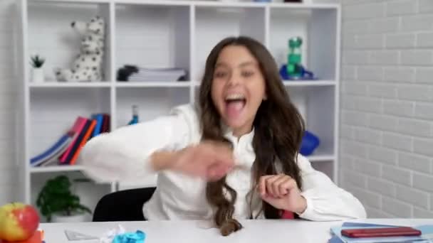 Funny child in school uniform playing throwing squeezed paper in classroom, school break — 비디오