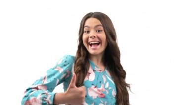 approval thumb up gesture of child with amazed happy face and curly hair isolated on white, approve