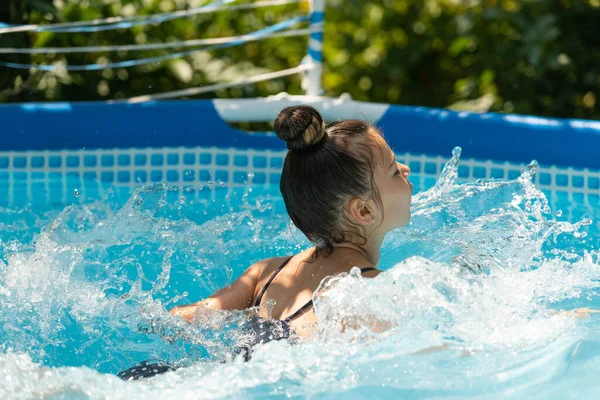 女の子の子供は夏休みにレジャープールで泳いだり、泳ぐのを楽しむ — ストック写真