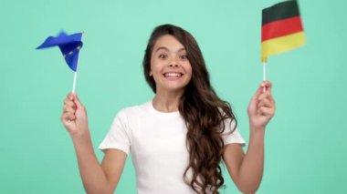 Avrupa Birliği ve Alman bayrağı sallayan mutlu genç kız futbol taraftarı gibi kutlama yapıyor.