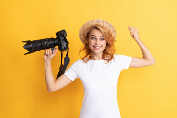 glad woman in straw hat photographing. girl hold photo camera.