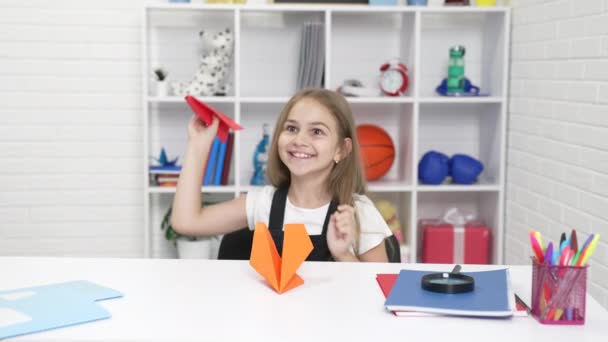 Criança se divertindo brincando com avião de papel na lição da escola enjoyng break, diversão em sala de aula — Vídeo de Stock