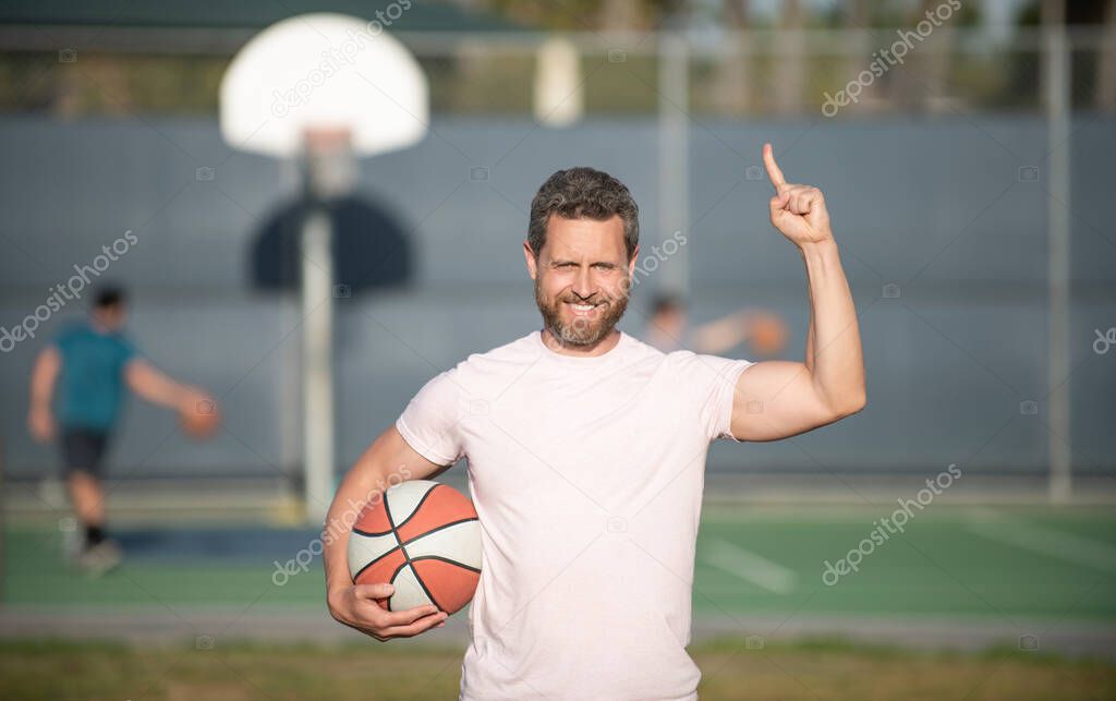 muscular man with basketball ball. sport trainer or basketball player. sport school.