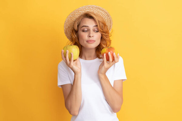 woman in straw hat eating healthy food. youth health. natural organic fresh apple