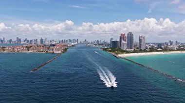 Miami 'de kumsalda güneşli yataklı, okyanus dalgalı bir plaj. Muhteşem manzaralı Miami Beach cenneti. Güney Sahili Miami cankurtaranı. Miami 'de huzurlu deniz kenarı inzivası