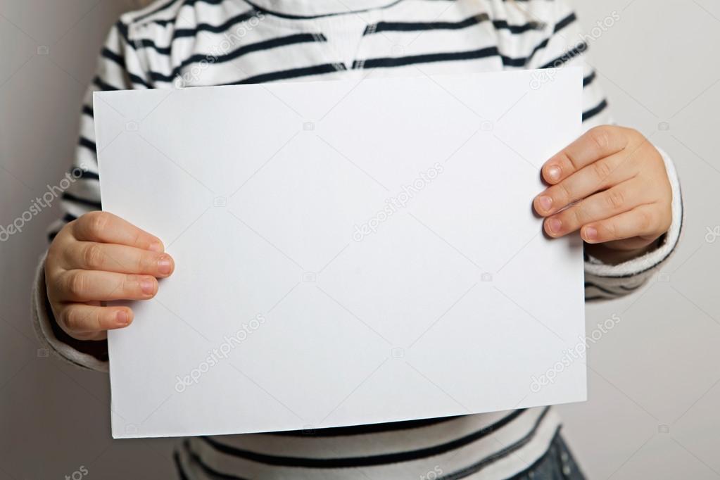 Blanke sheet of paper in child's hands