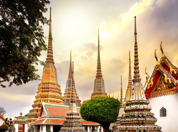 Klasszikus Thai építészet, a Wat Pho templom nyilvános drámai narancssárga naplemente ég, Bangkok, Thaiföld. — Stock Fotó