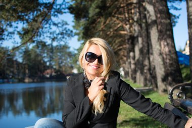 Young attractive girl with beautiful long blond hair, photographed in a park.