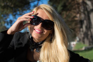 Young attractive girl with beautiful long blond hair and black glasses.