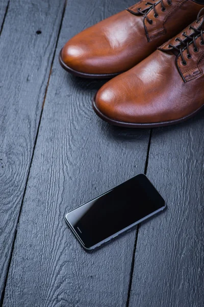 Brown leather shoes on black floor — Stock Photo, Image