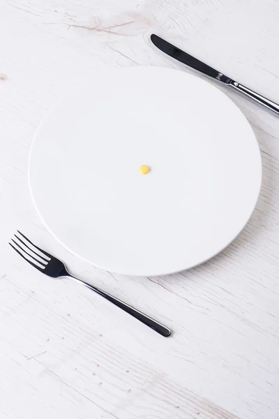 Assiette avec fourchette, couteau et pilule — Photo