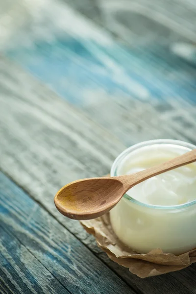Frasco com iogurte fresco em uma mesa rústica — Fotografia de Stock