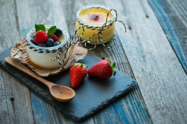 Ahşap masa üzerinde çilek ile taze ve sağlıklı doğal yoğurt
