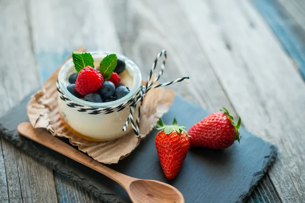 Fresh and healthy natural yogurt with berries on wooden table — Stock Photo, Image