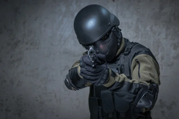 Terrorist in helmet with big gun in hands — Stock Photo, Image