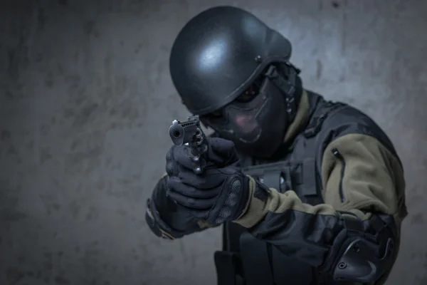 Terrorist in helmet with big gun in hands — Stock Photo, Image
