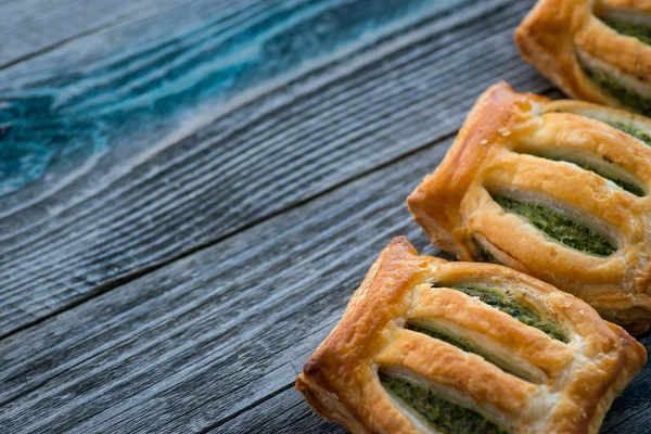 Freshly baked spinach pie on a rustic wooden table