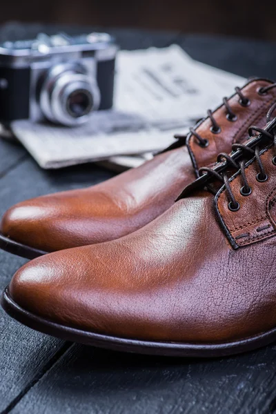 Brown leather shoes on black floor — Stock Photo, Image