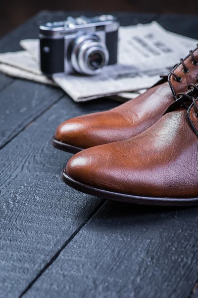 Brown leather shoes on black floor — Stock Photo, Image