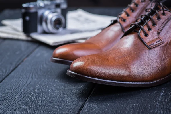 Brown leather shoes on black floor — Stock Photo, Image