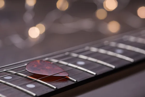 Guitar frets with mediator on strings — Stock Photo, Image