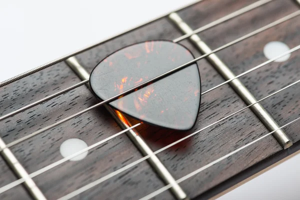 Guitar frets with strings and mediator — Stock Photo, Image